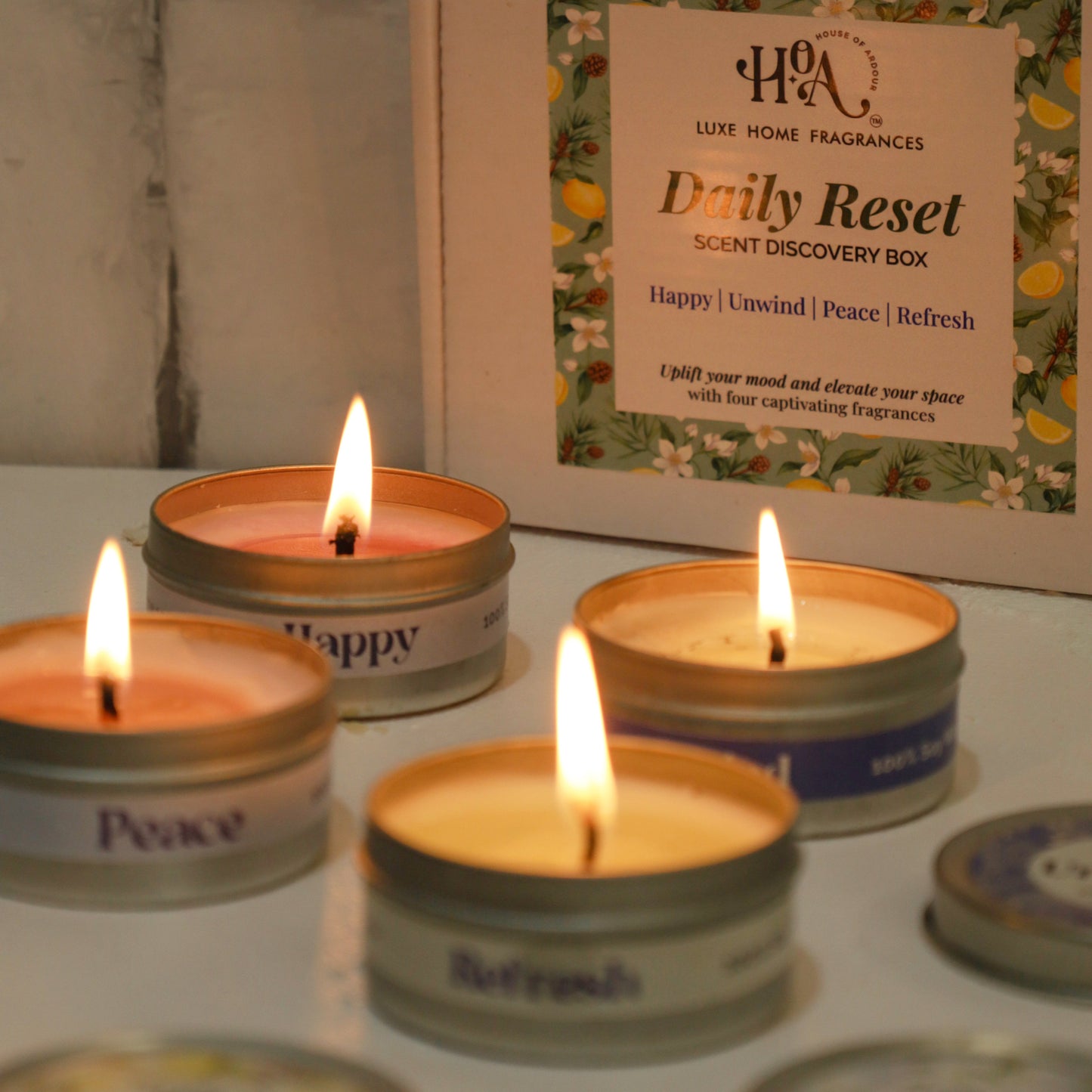 Lit candles in small containers with a 'Daily Reset' box in the background.