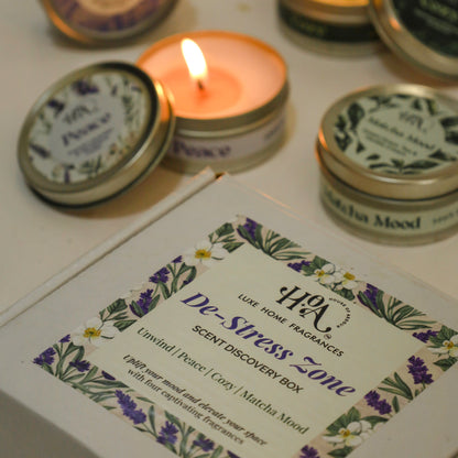 Candle and tins with labels on a white surface