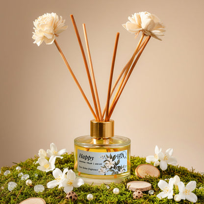 a reed diffuser surrounded by fresh jasmine flowers