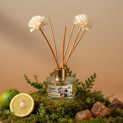 Reed diffuser with bergamot, floral design and dry amber on a natural background