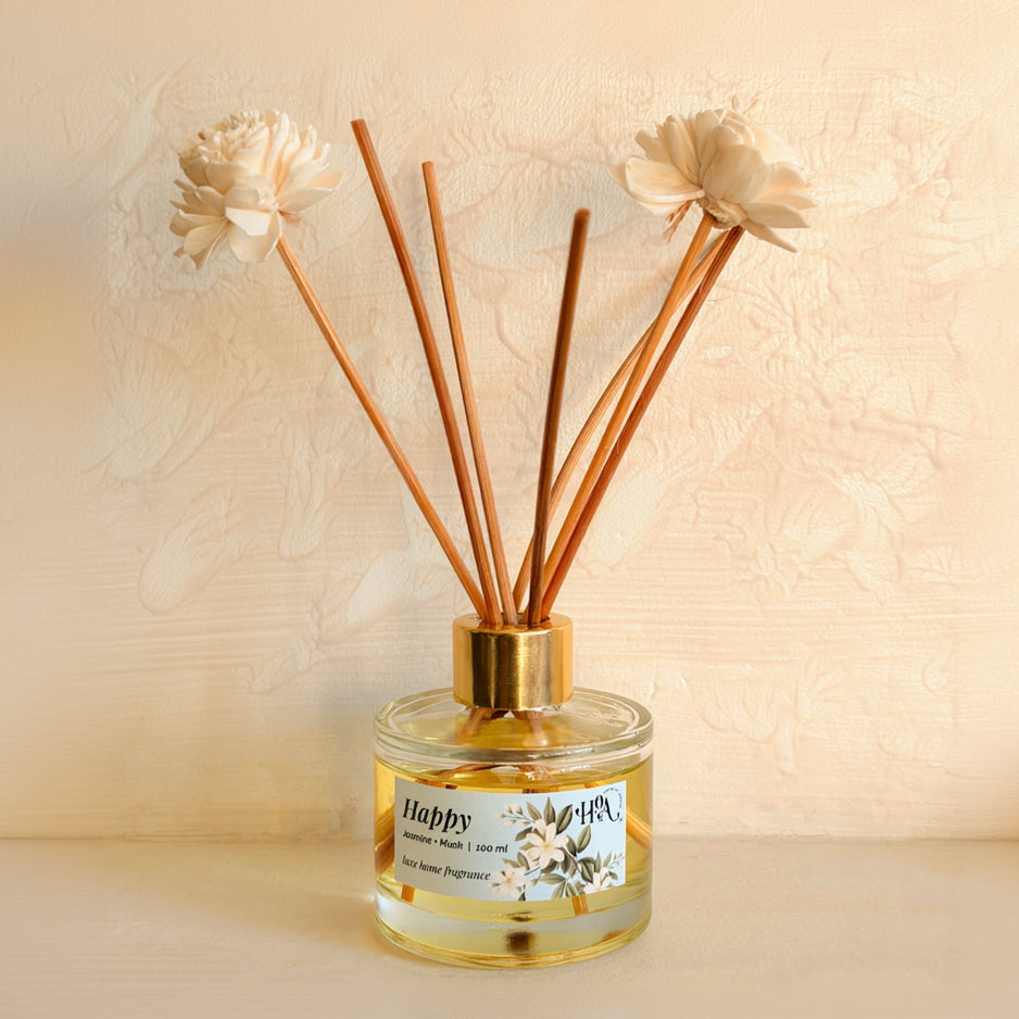 Diffuser with wooden sticks and decorative flowers on a beige background