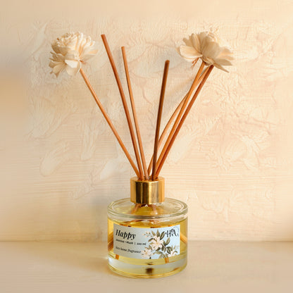 Diffuser with wooden sticks and decorative flowers on a beige background